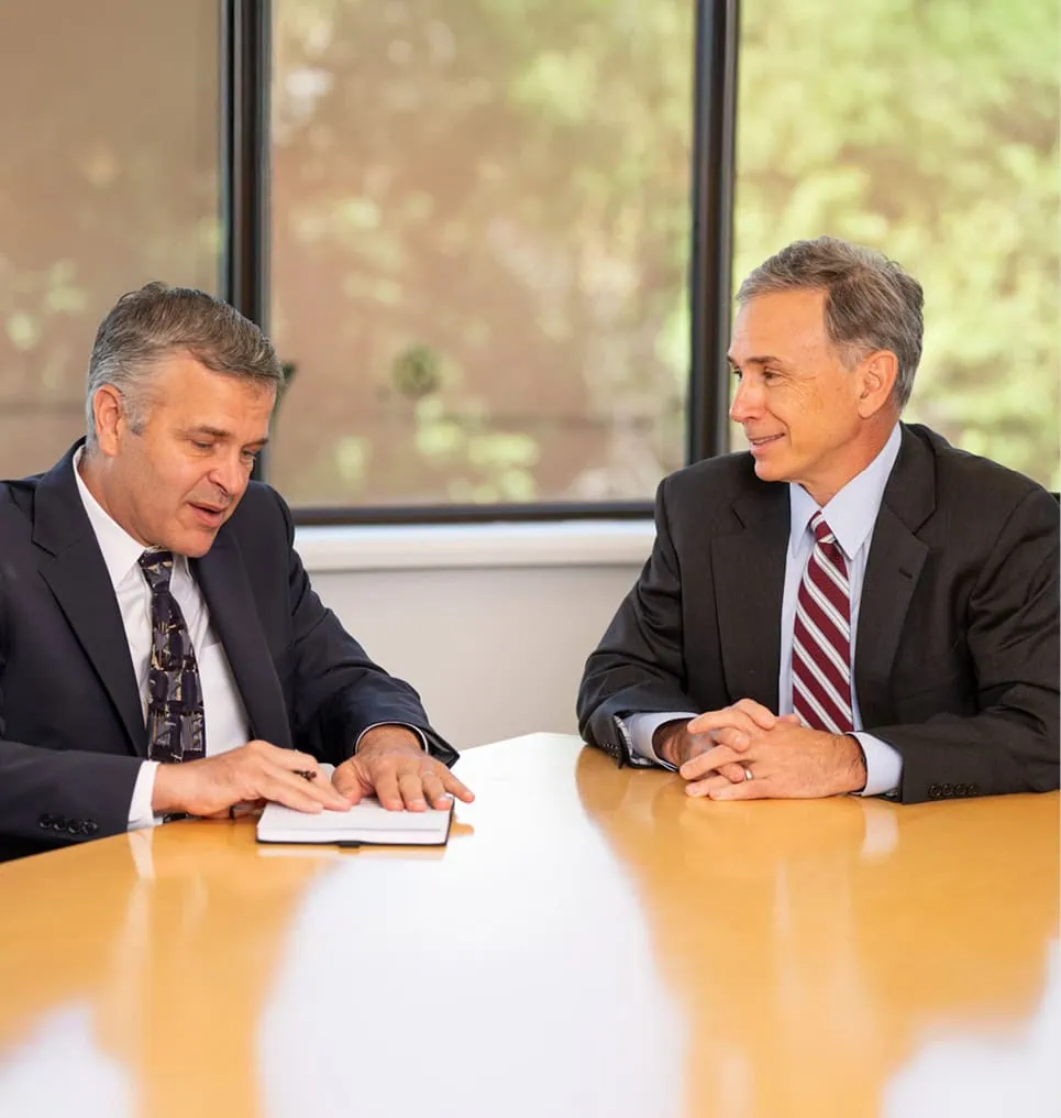 IP and Patent Lawyer Onello & Mello talking at a conference room table