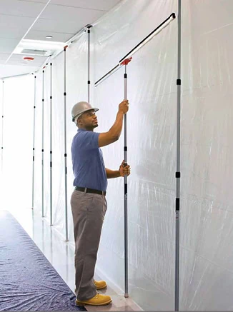 Man with a hardhat and plastic sheeting