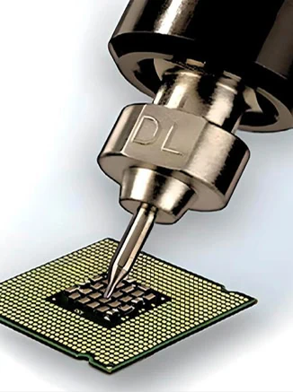 A closeup of a soldering gun and a circuit